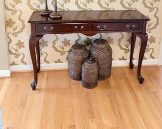 Another view of the Mahogany console / entryway table with 2 drawers and rattan woven canister - set of 3.