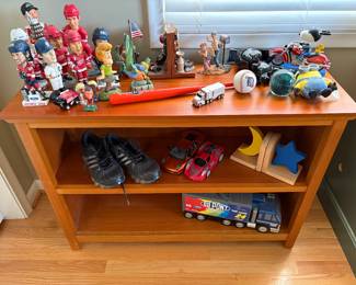 Sport Bobbleheads and more shown on 2 shelf bookcase