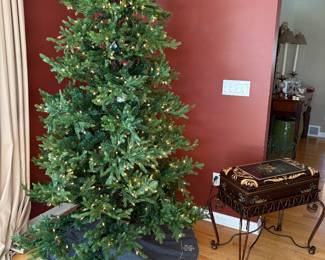 Faux lit Christmas tree and skirt and another view of the storage box with iron legs