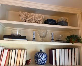 Ginger jar, candle holders, books, and glass dishes