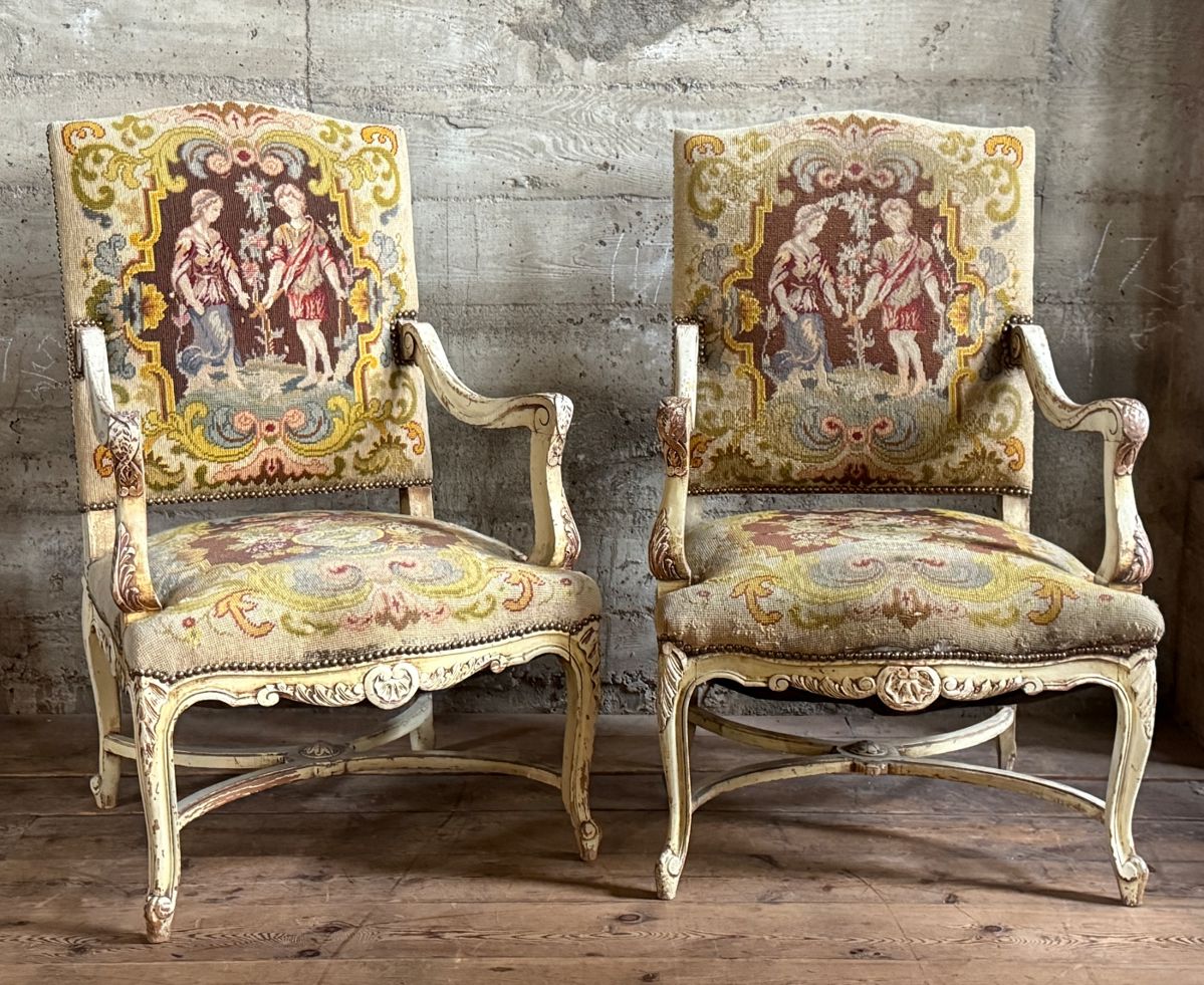 This lot features a pair of 19th century French Louis XV style armchairs with original tapestry upholstery and a painted, carved wood frame. Each chair measures, 41” H x 25” W x 21.5” D.
