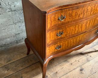 This lot features an antique George III style burr walnut serpentine chest of drawers that measures, 34” H x 38” W x 19” D.
