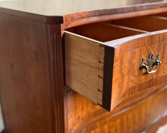 This lot features an antique George III style burr walnut serpentine chest of drawers that measures, 34” H x 38” W x 19” D.
