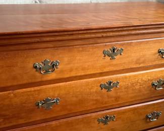 This lot features a solid cherry wood Chippendale-style chest of drawers with original brass pulls that measures, 37.5” H x 41” W x 19.5” D.
