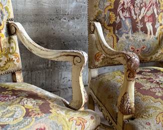 This lot features a pair of 19th century French Louis XV style armchairs with original tapestry upholstery and a painted, carved wood frame. Each chair measures, 41” H x 25” W x 21.5” D.
