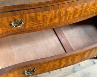 This lot features an antique George III style burr walnut serpentine chest of drawers that measures, 34” H x 38” W x 19” D.
