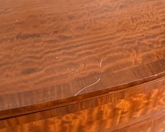 This lot features an antique George III style burr walnut serpentine chest of drawers that measures, 34” H x 38” W x 19” D.
