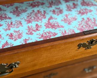 This lot features a solid cherry wood Chippendale-style chest of drawers with original brass pulls that measures, 37.5” H x 41” W x 19.5” D.
