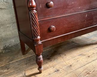 This lot features a 19th century American Empire mahogany chest of drawers that measures, 38” H x 46” W x 20” D.
