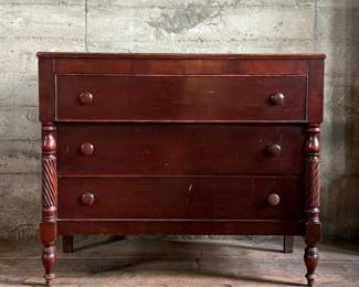 This lot features a 19th century American Empire mahogany chest of drawers that measures, 38” H x 46” W x 20” D.
