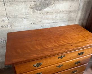 This lot features a solid cherry wood Chippendale-style chest of drawers with original brass pulls that measures, 37.5” H x 41” W x 19.5” D.
