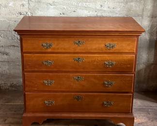 This lot features a solid cherry wood Chippendale-style chest of drawers with original brass pulls that measures, 37.5” H x 41” W x 19.5” D.
