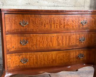 This lot features an antique George III style burr walnut serpentine chest of drawers that measures, 34” H x 38” W x 19” D.
