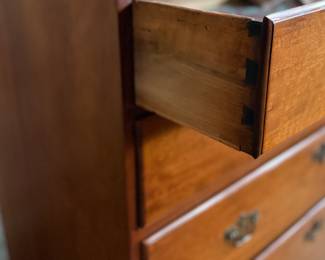 This lot features a solid cherry wood Chippendale-style chest of drawers with original brass pulls that measures, 37.5” H x 41” W x 19.5” D.
