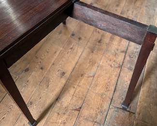 This lot features an antique George III solid mahogany game table. This table is in good overall condition, but does have one loose leg shown in photos. This table measures closed, 29” H x 19” W x 36” D and open, 29” H x 38” W x 36” D.

