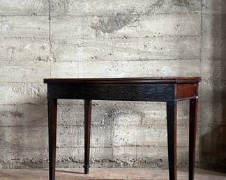 This lot features an antique George III solid mahogany game table. This table is in good overall condition, but does have one loose leg shown in photos. This table measures closed, 29” H x 19” W x 36” D and open, 29” H x 38” W x 36” D.
