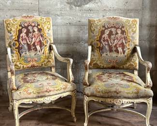 This lot features a pair of 19th century French Louis XV style armchairs with original tapestry upholstery and a painted, carved wood frame. Each chair measures, 41” H x 25” W x 21.5” D.
