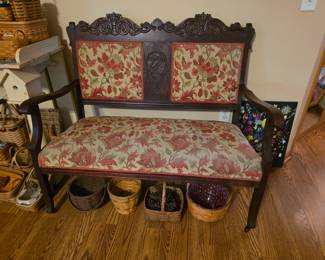 antique Victorian Eastlake-style walnut settee with a floral upholstered seat and back.  Excellent condition!!