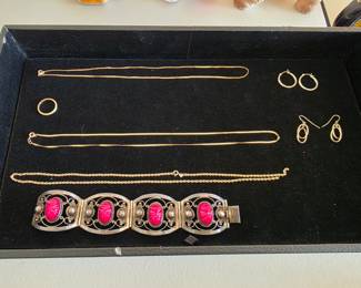 Gold jewelry and a sterling silver bracelet.