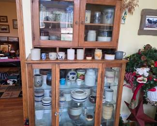 Crocks and other fantastic ceramic items! Inside two Beautiful antique wooden cabinets with glass doors.