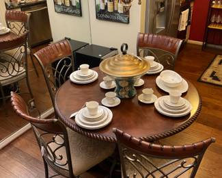 ROUND TABLE AND FOUR WROUGHT IRON CHAIRS