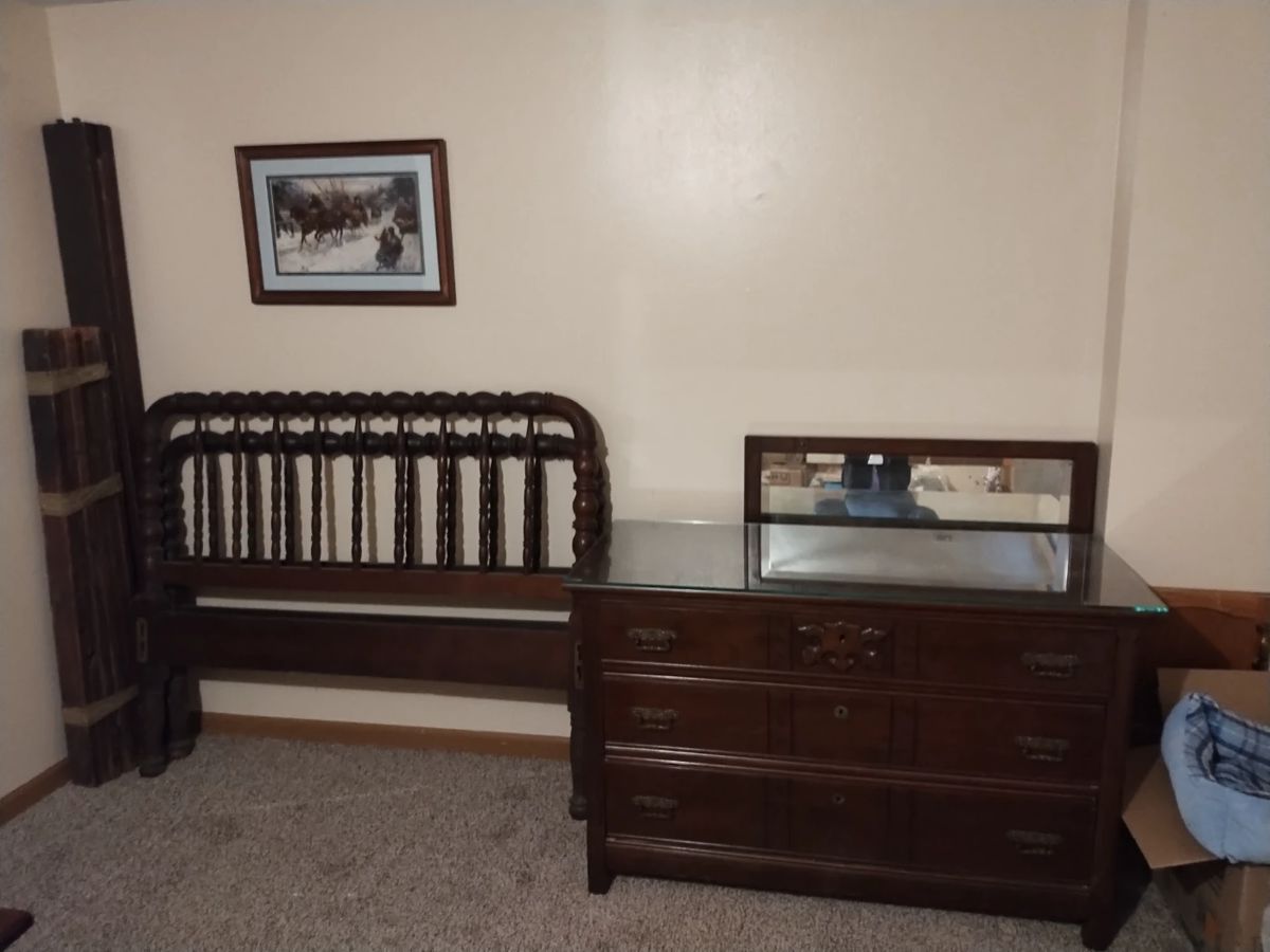 Antique Jenny Lind bed w/rails and glass top dresser with mirror.