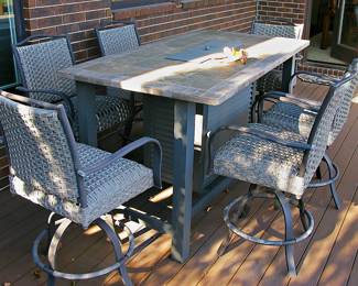  Outdoor Dining set Featuring Table with a Fire Pit Insert and Coordinating Woven-Rattan  Swivel Chairs. 