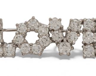 Lot 92
TIffany & Co Diamond "Love" Brooch, Platinum 1970, W 1.3" 6 g