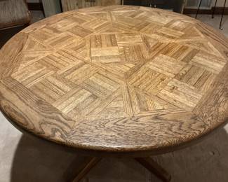 The top of the MCM round parquet table