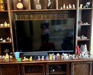 Entertainment center with collectibles and dog figurine's