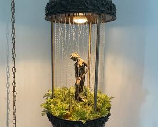 Vintage oil rain lamp featuring a goddess figurine and cascading oil beads. 