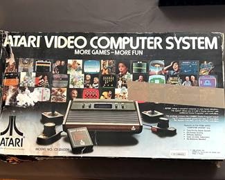 Two vintage Atari 2600s, one in original box.