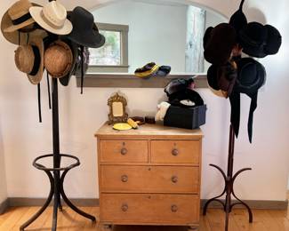 A range of hats in many shapes and designs, coat rack #1, coat rack #2