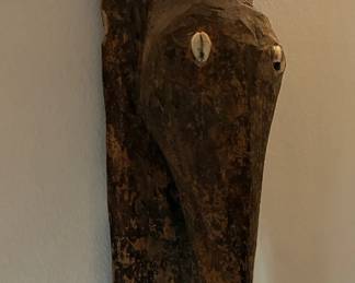 Hand carved African sculpture with cowrie shells