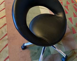 Black adjustable wheeled crescent chair