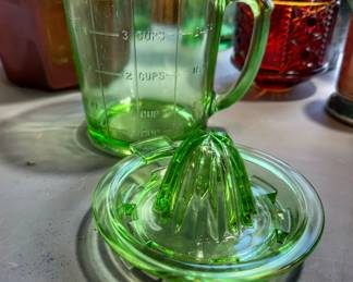 Vintage vaseline (aka uranium) glass cup and juicer combination.