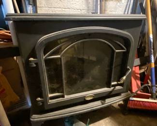 Cast iron fireplace insert with arched glass door