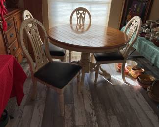 cream colored round table -48x30  four chairs-21x40, leaf-12”