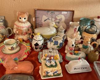 very cute collection of teapots,butter dishes, & cookie jars