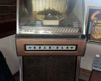 This is a vintage Rock-Ola jukebox from the mid-1950s.