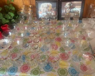 Lots of gold rimmed champagne, wine and drinking glasses