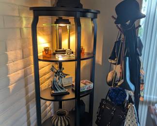 Purses and hat! Interesting knick knacks on the shelf. Writing pens, Cool lamp!