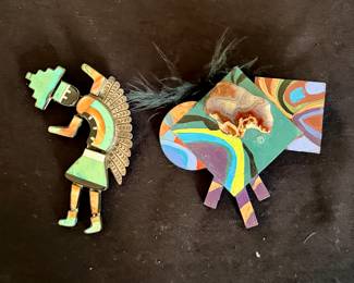 Zuni "Rainbow Man" brooch (left); handcrafted brooch by Betsy Stewart