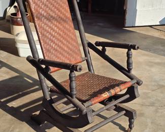 Antique Victorian Hunzinger platform rocker with a woven seat and back.