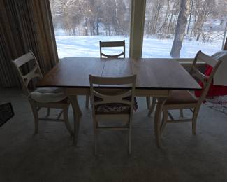 This is a two-tone farmhouse style dining table and chairs set, likely made with a dark brown wood top and white base and chairs. 