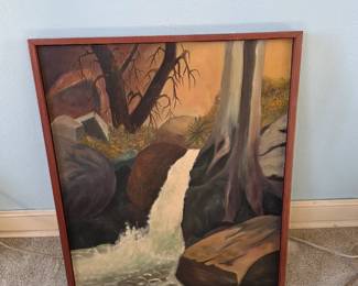 


The image is of an original landscape oil painting featuring a waterfall and trees in a wooden frame. 