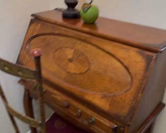 A Small Desk, Chair, And Lamp