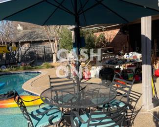 Table and chairs with large umbrella.