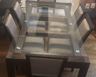 Table measures 42 inches wide and 76 inches long. The chairs are approximately 39 inches high.
Purchased  from Raymour and Flanagan over 4 years ago  

6 chairs have gray fabric on the backing and on the seating area 
