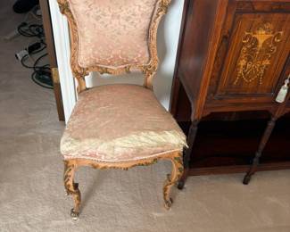 Louis XV style carved mahogany accent chair with pink damask patterned upholstery.